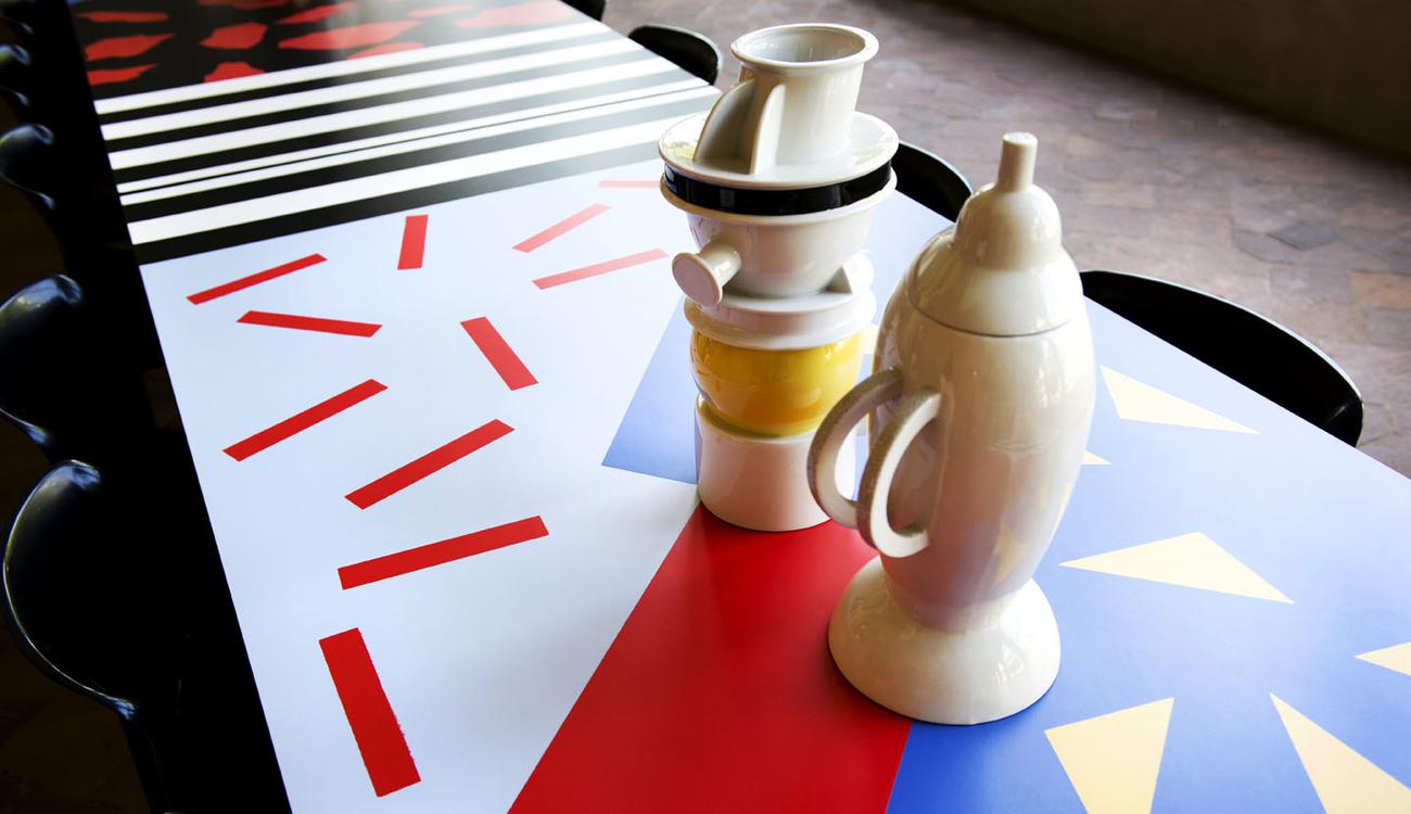Interni 60th anniversary table setting: white ceramic vessels on a graphic patterned tablecloth