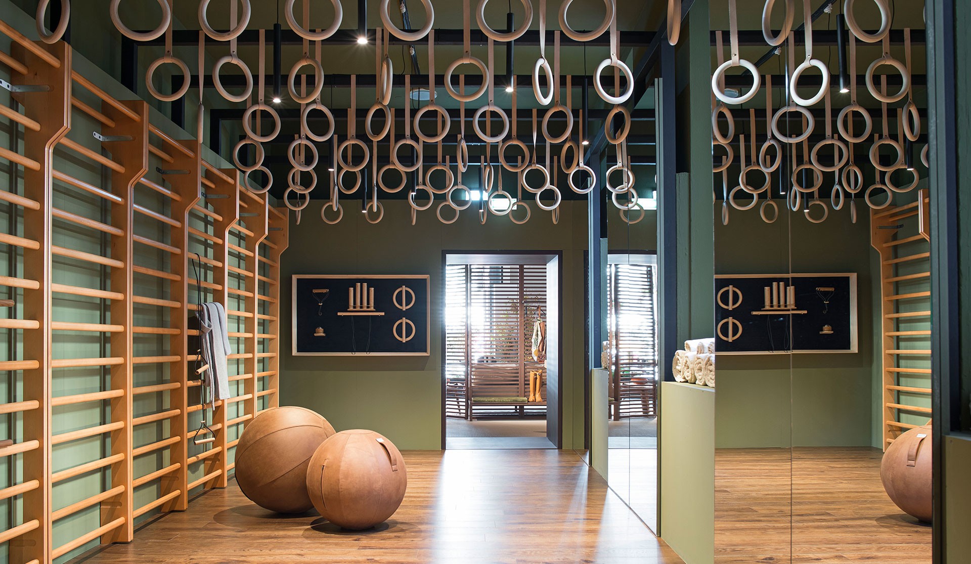 Elle Decor Grand Hotel Design Therapy: gym with wooden wall bars, hanging rings and leather balls