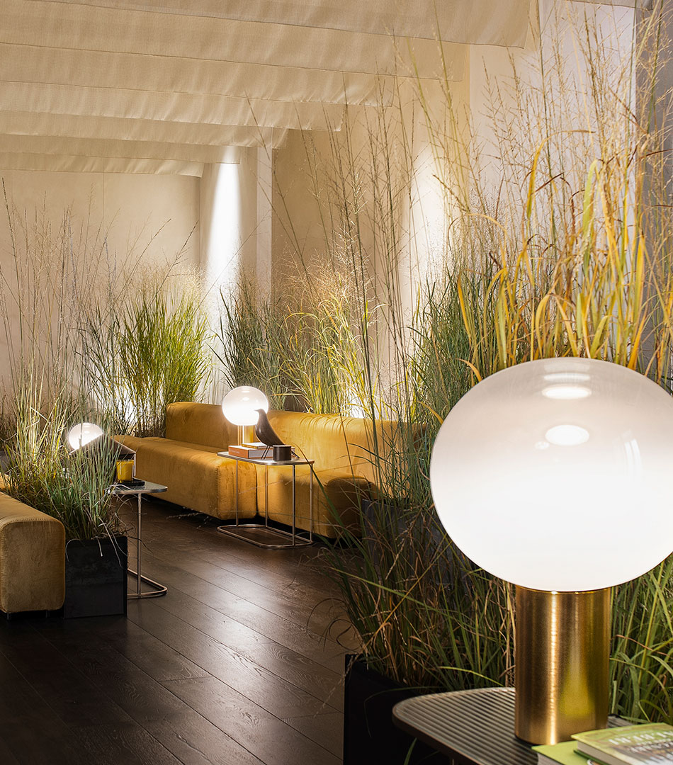 Elle Decor Grand Hotel Design Therapy: lounge with tall grasses, a globe lamp and low sofas
