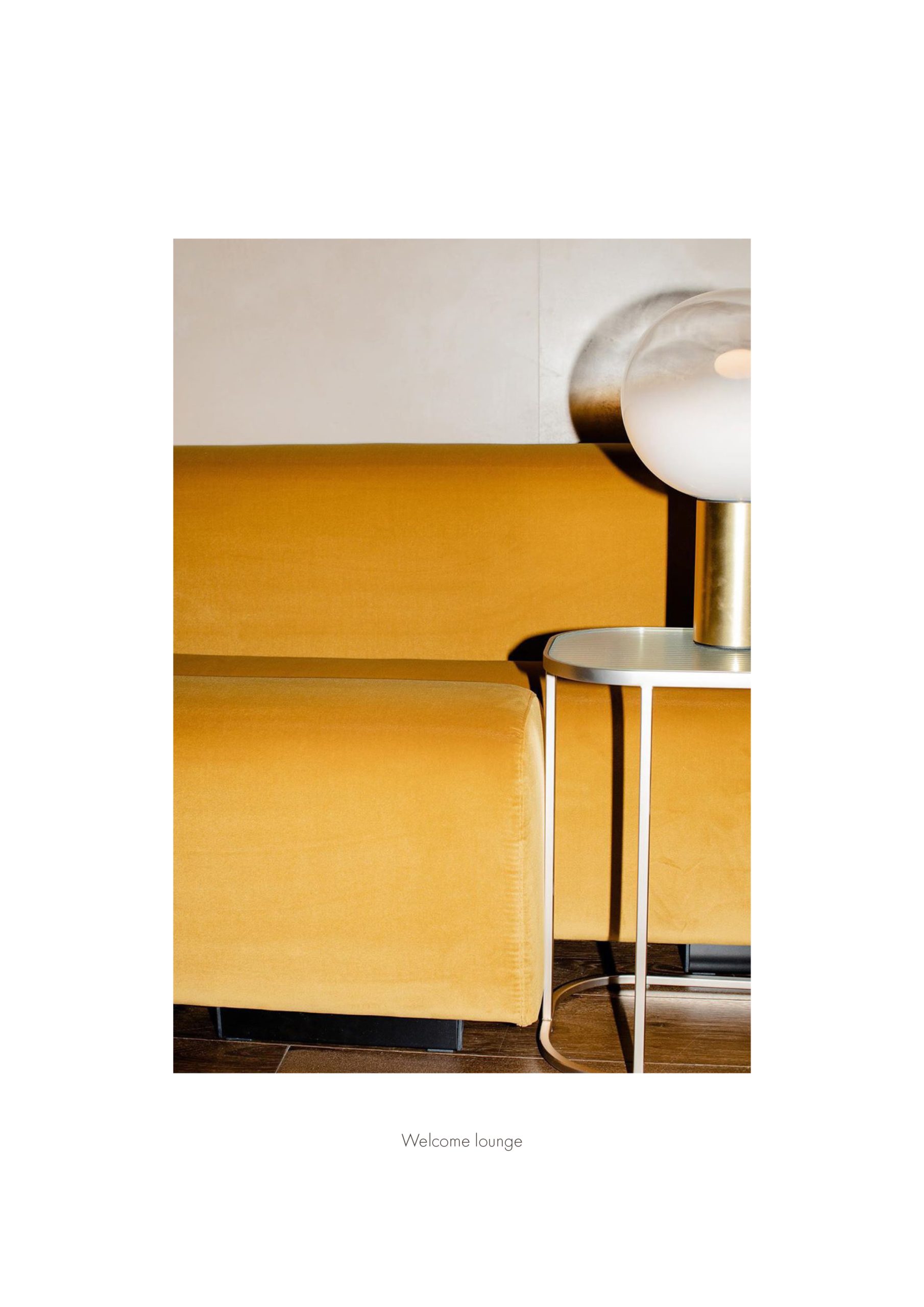 Elle Decor Grand Hotel Design Therapy: ochre sofa and side table in the welcome lounge, from the project booklet