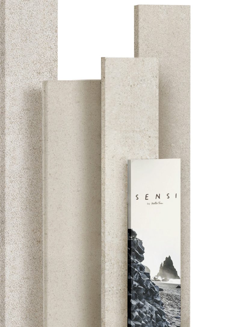 Florim Sensi porcelain stoneware slabs standing upright with the collection brochure.