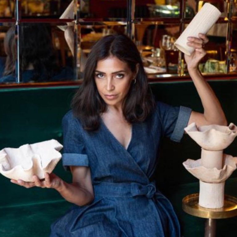 Il tempo, le sue parole per terra: woman in a denim dress holding wavy ceramic pieces