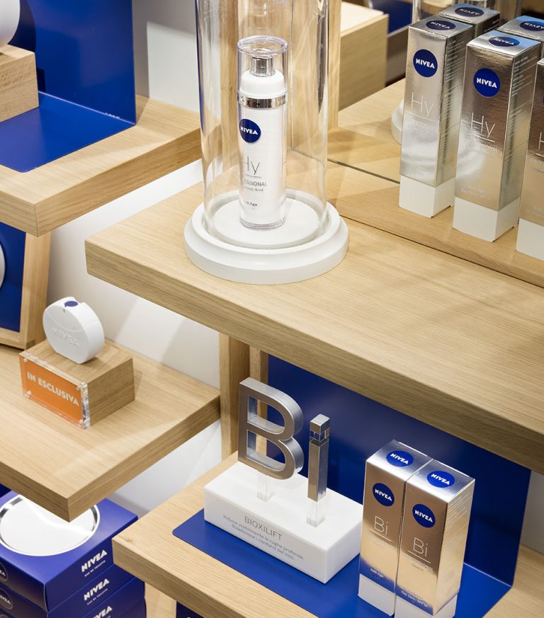 Retail system for NIVEA: product under a glass cloche on an oak display