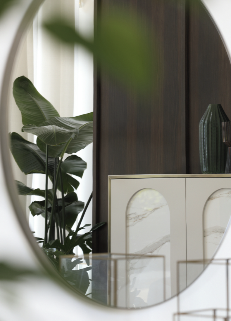 Showroom for Capital Interiors: interior reflected in a round mirror with plants and an arched cabinet