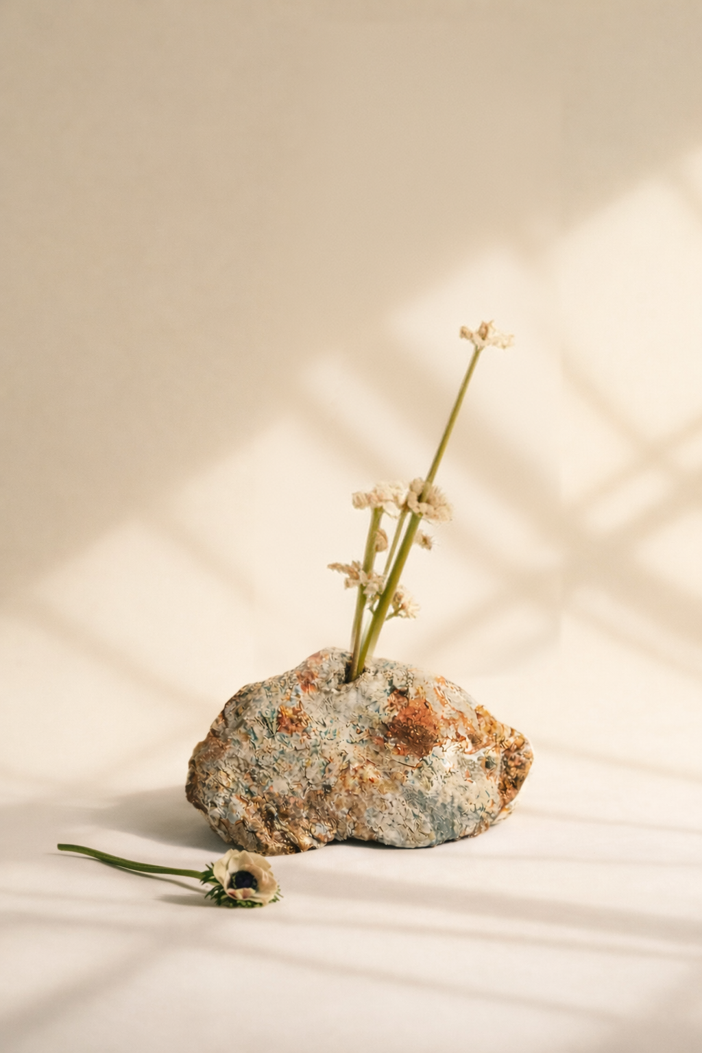 Wildflower Superbloom: ceramic stone holding a stem of white flowers