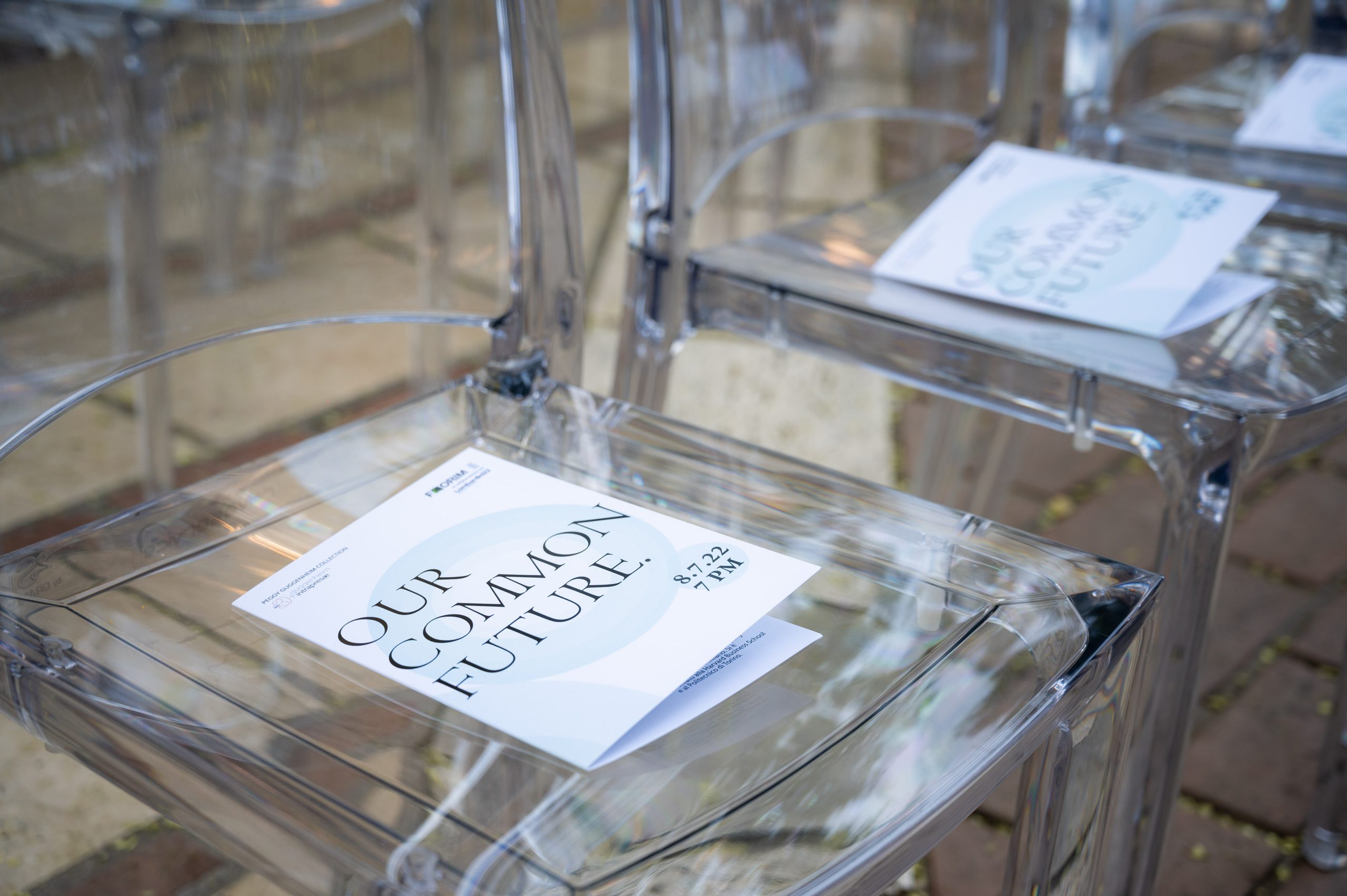 Our Common Future, Guggenheim: event card resting on a transparent chair