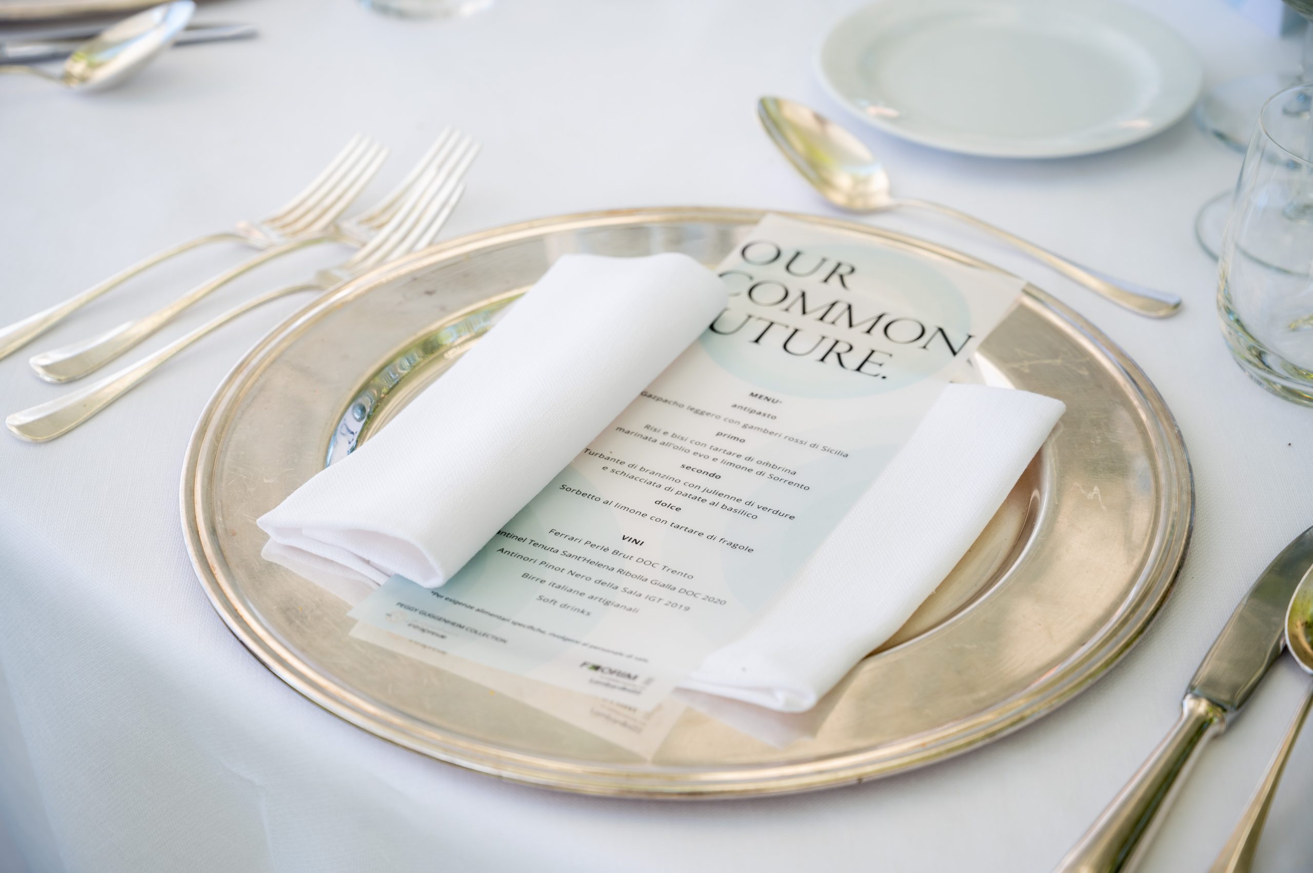 Our Common Future, Guggenheim: place setting with a silver charger and the printed menu