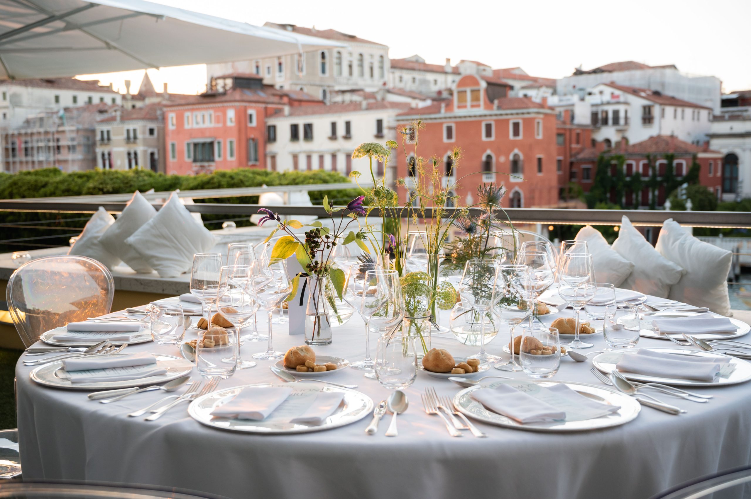 Our Common Future, Guggenheim: round dinner table set on a terrace overlooking Venice