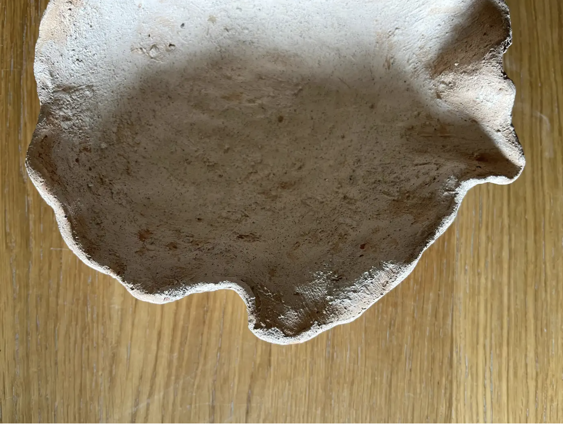 Dare forma alla terra, Santorini: inside of a wavy ceramic dish with a rough clay surface