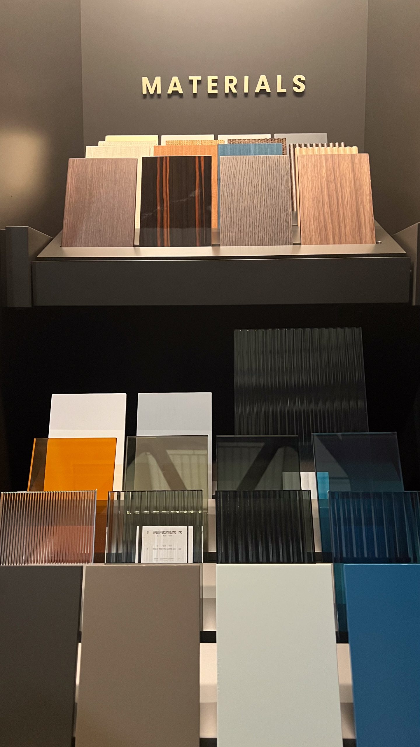 Effebiquattro Milano brand image: materials wall with wood and glass samples