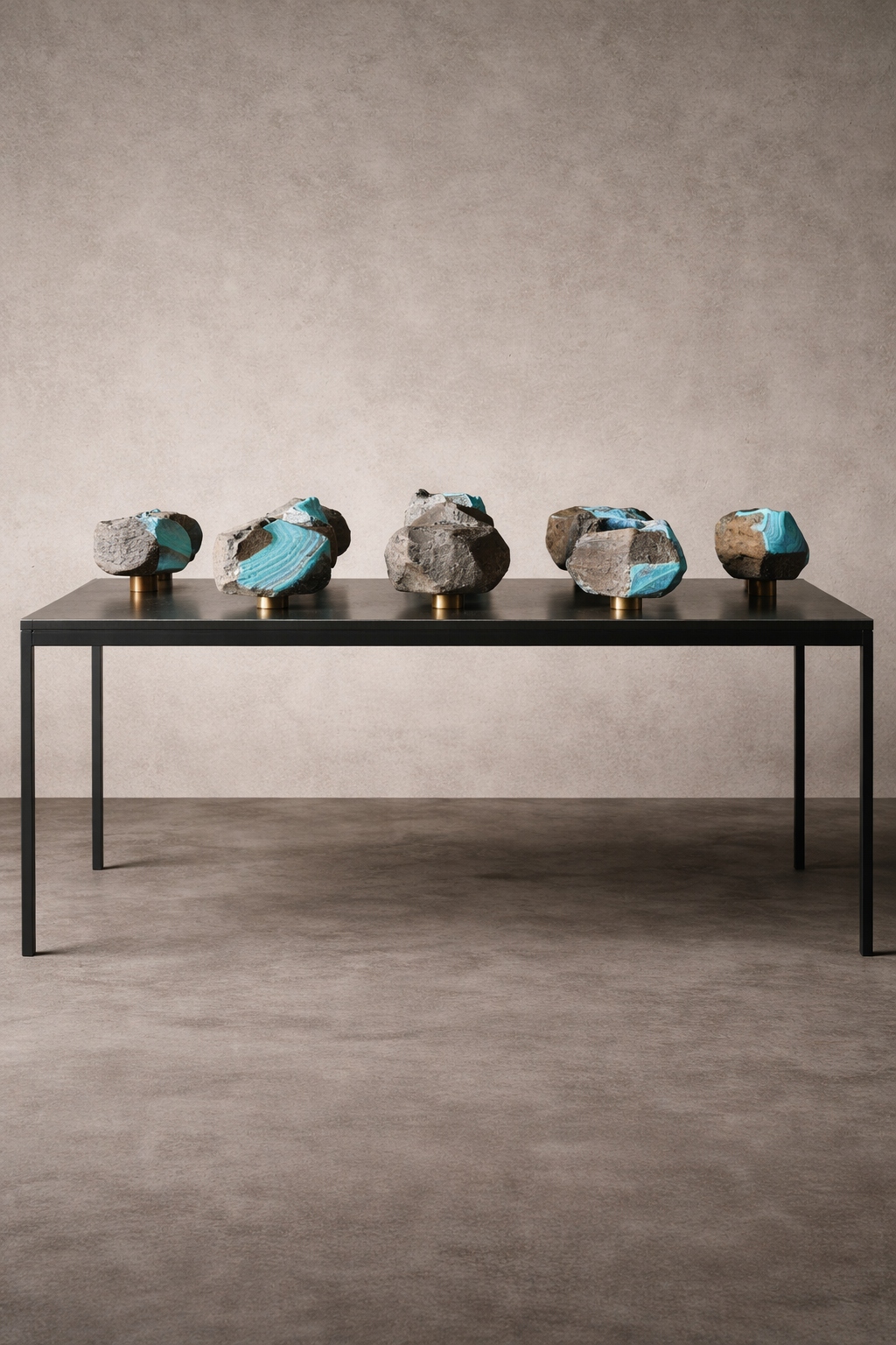 Portal of Memory: five ceramic stones on a black steel table