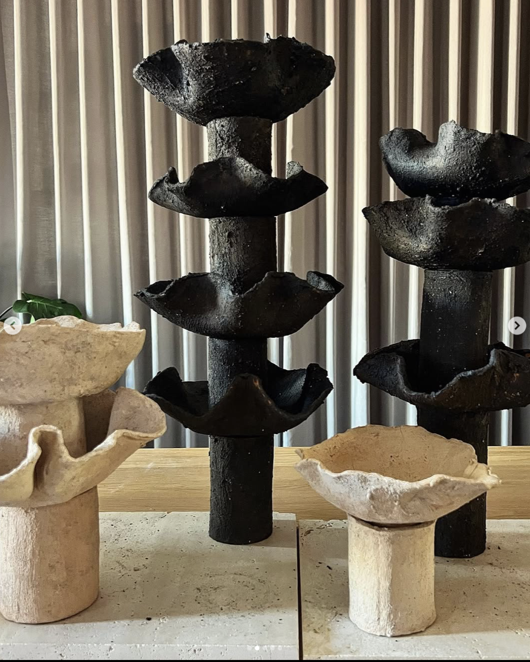 Retention Unit: dark and pale ceramic columns with stacked wavy basins