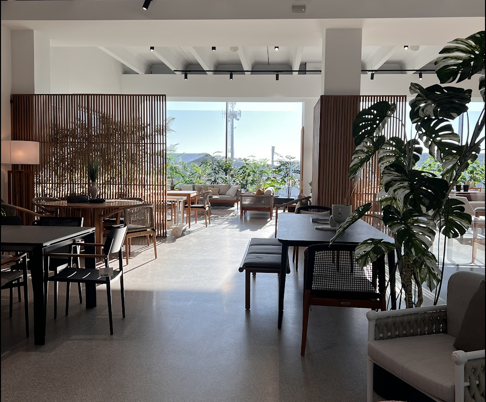 Atmosphera headquarters: showroom with dining tables, timber screens and plants
