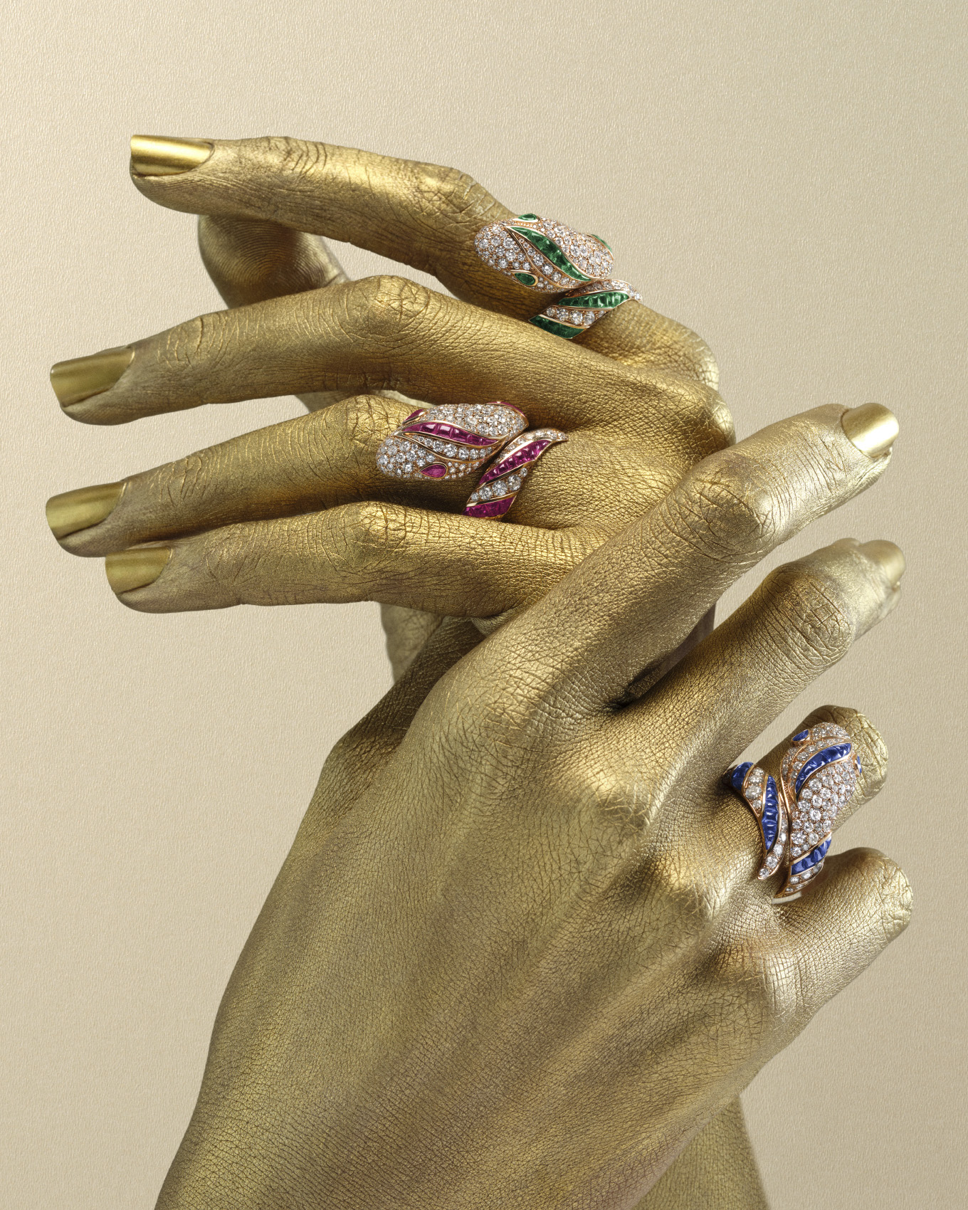 Bulgari Serpenti frames for Harper's Bazaar: gold-painted hands wearing jewelled Serpenti rings