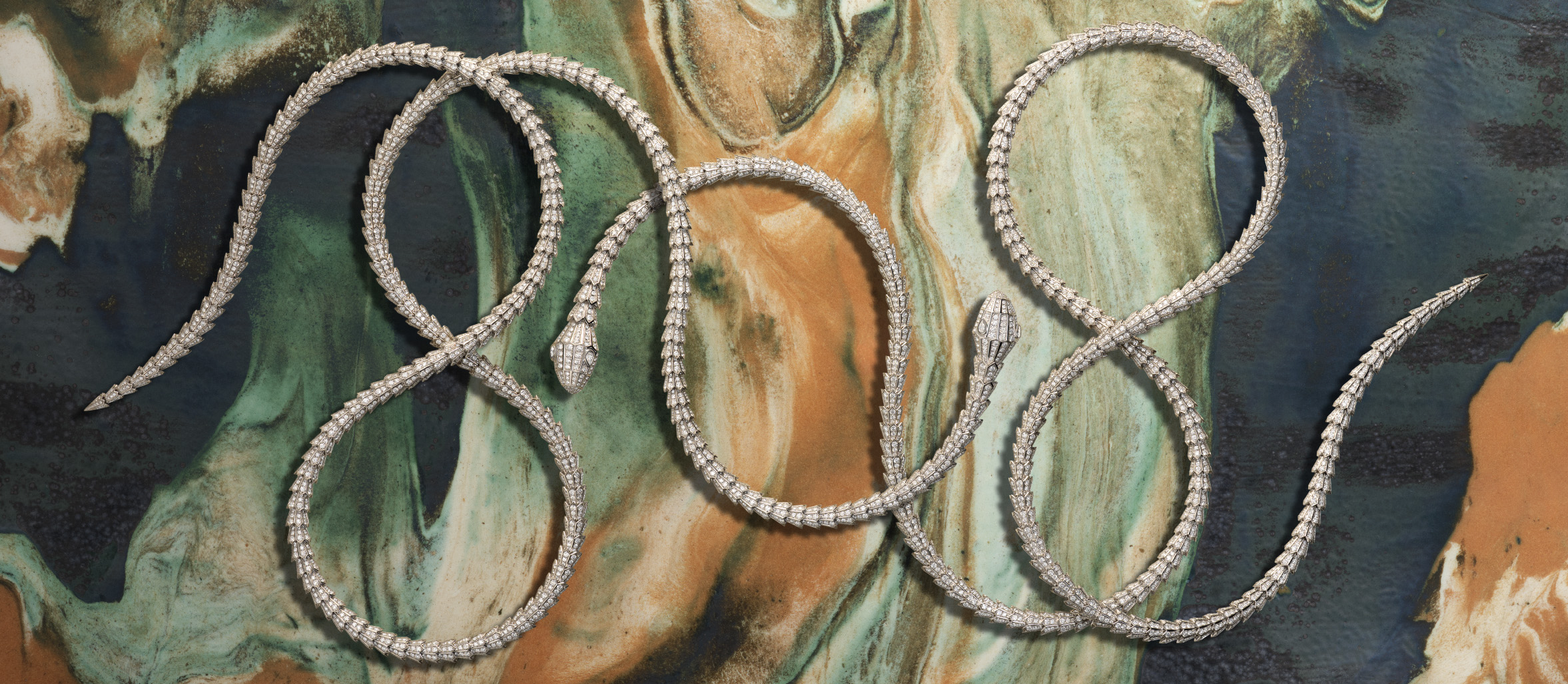 Bulgari Serpenti frames for Harper's Bazaar: intertwined Serpenti pieces on a marbled ceramic ground