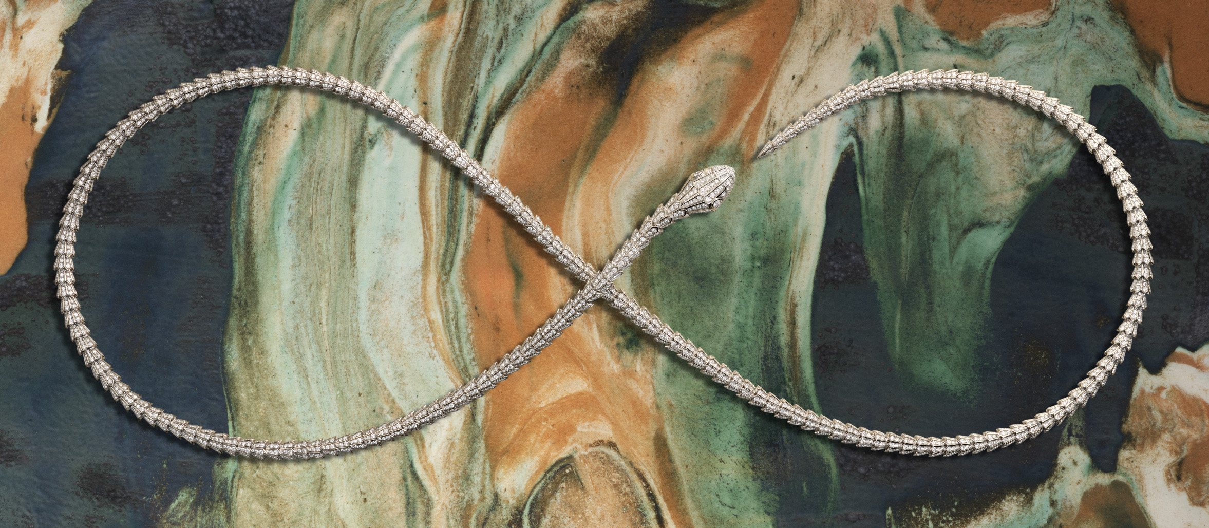Bulgari Serpenti frames for Harper's Bazaar: Serpenti necklace in an infinity loop on marbled ceramic