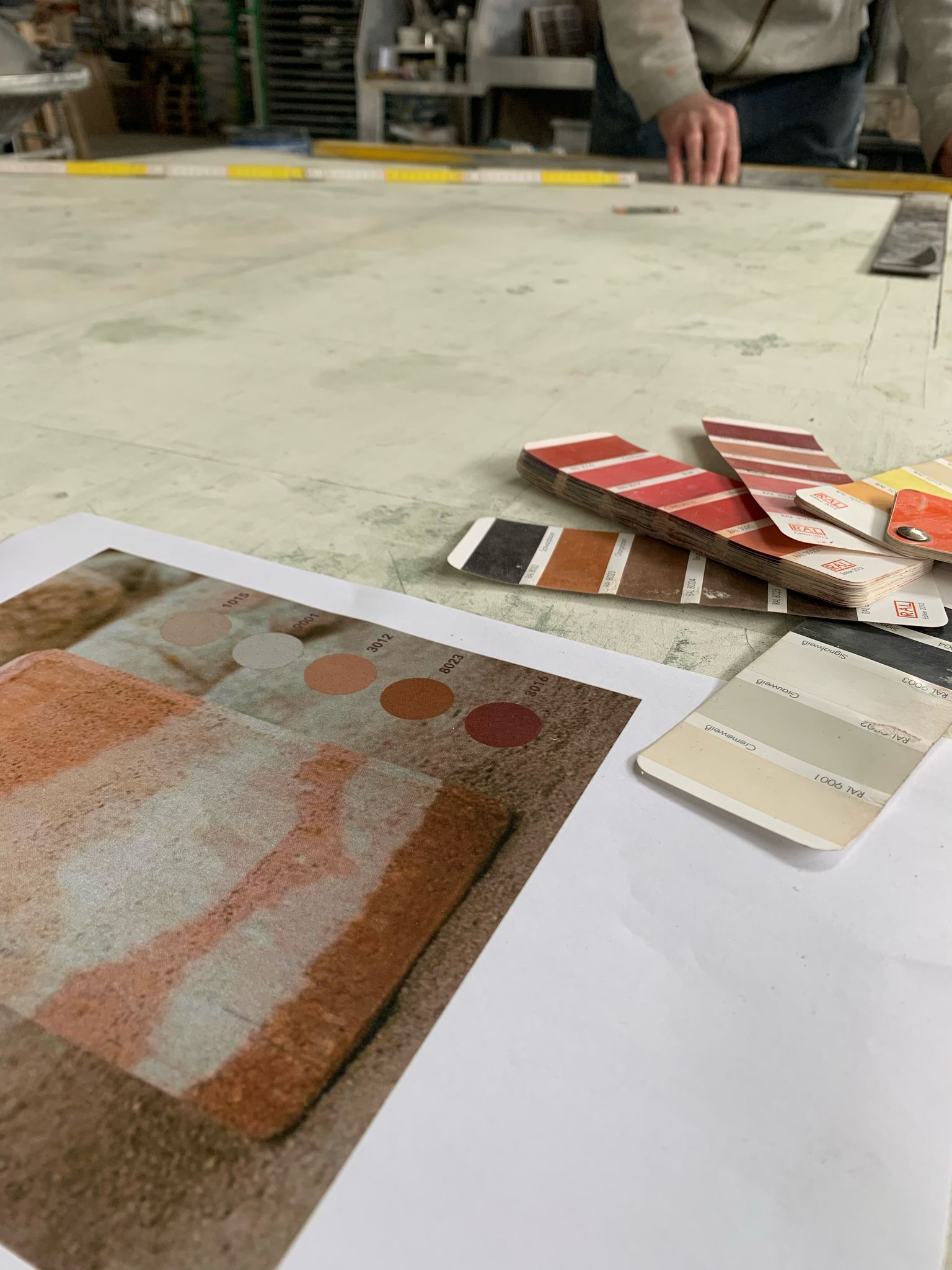Stratigrafica collection: earth-tone samples and colour swatches on the workbench
