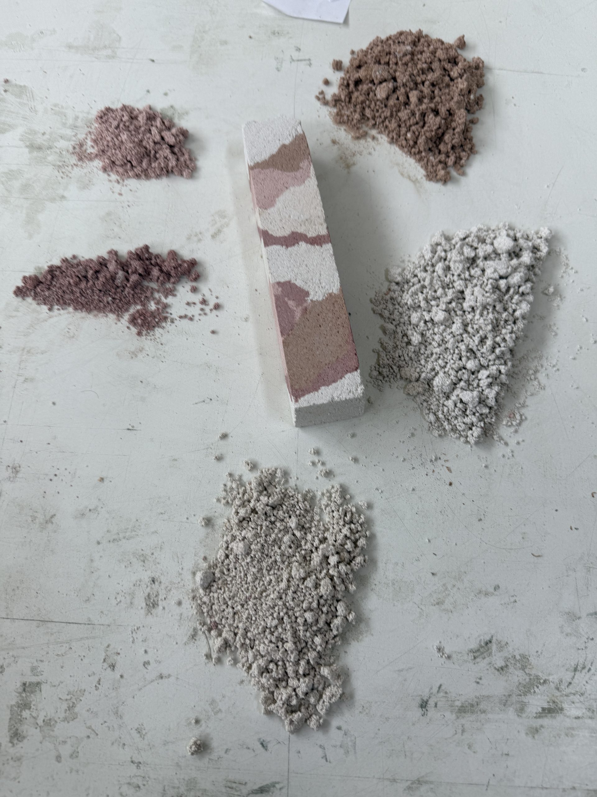 Stratigrafica collection: layered sample bar among heaps of crushed stone and earth