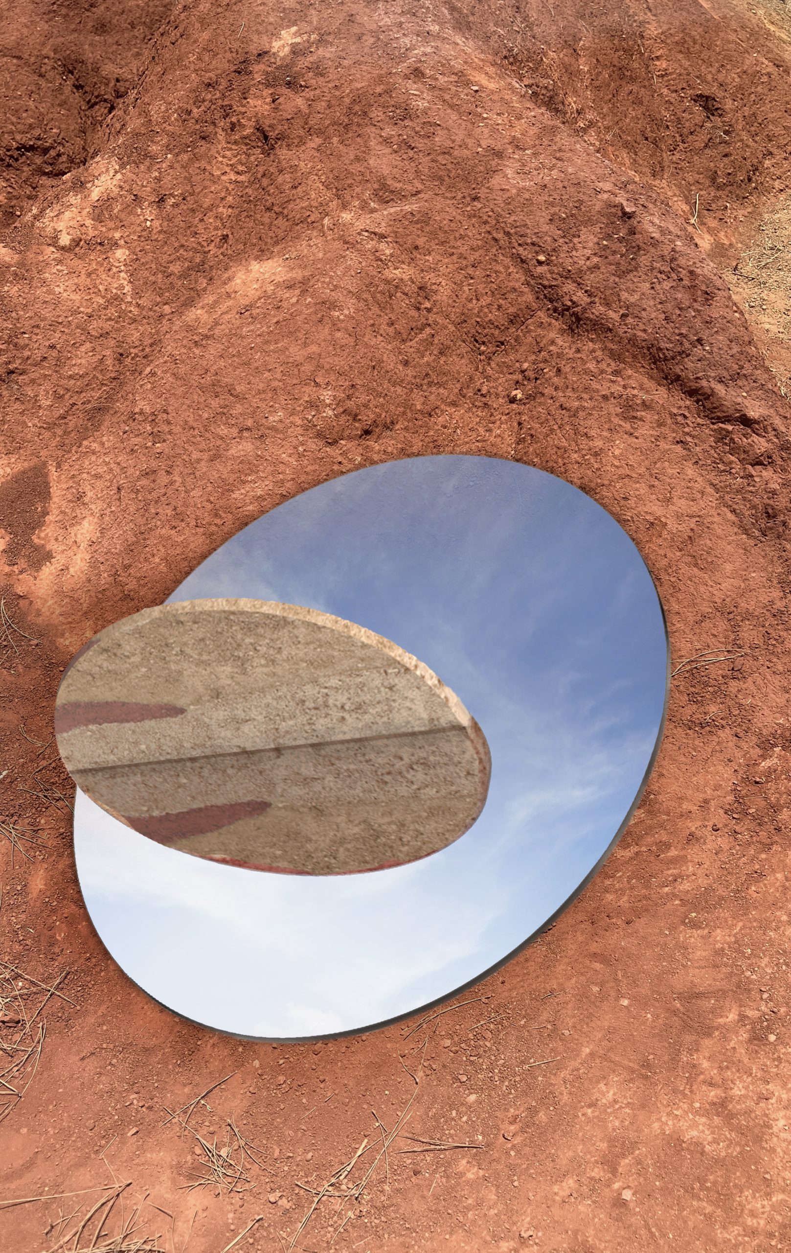 Stratigrafica collection: round mirror with a stone disc lying on red earth