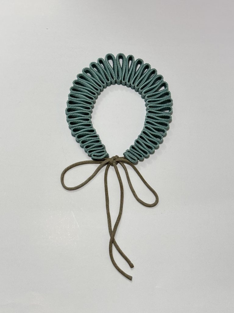 Pleated cord necklace in teal with olive ties, from the Plissè collection by Elena Pelosi.