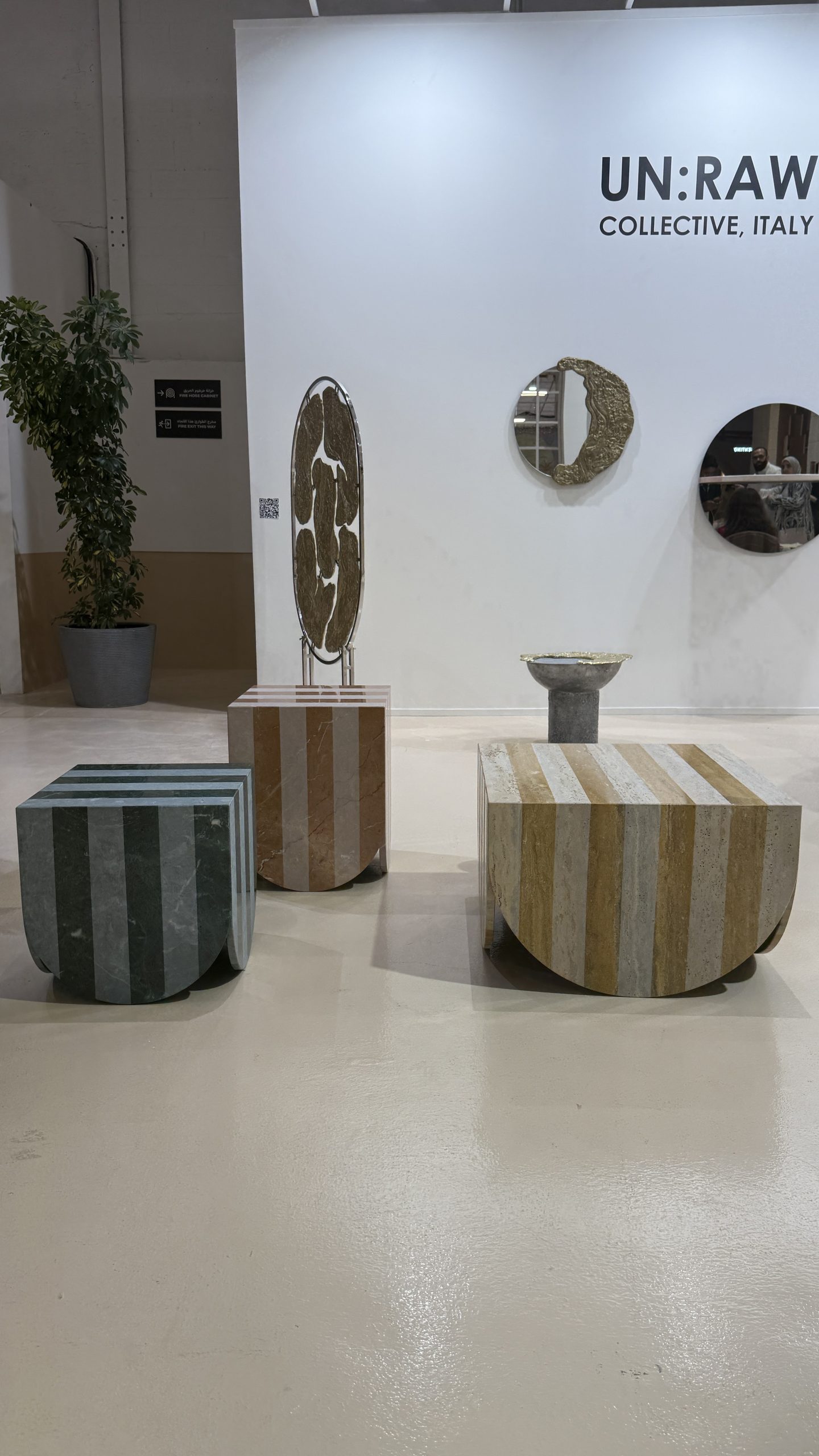 UN:RAW Collective in Riyadh: striped ceramic stools and round mirrors in the exhibition space