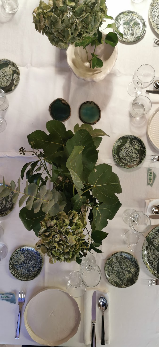 Made in Fornace, The Dinner: overhead view of the table with green plates and flowers