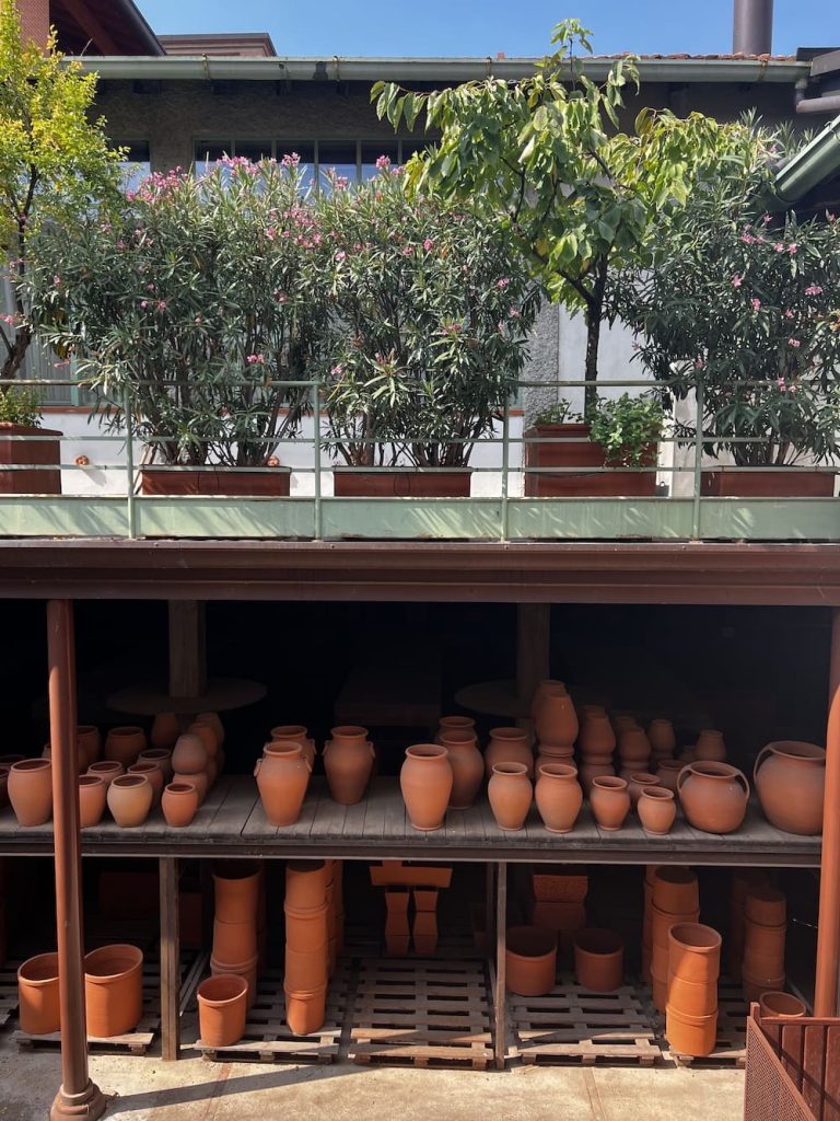 Conosco un posto: Fuorisalone 2026 guide, terracotta pots on shelves at Fornace Curti