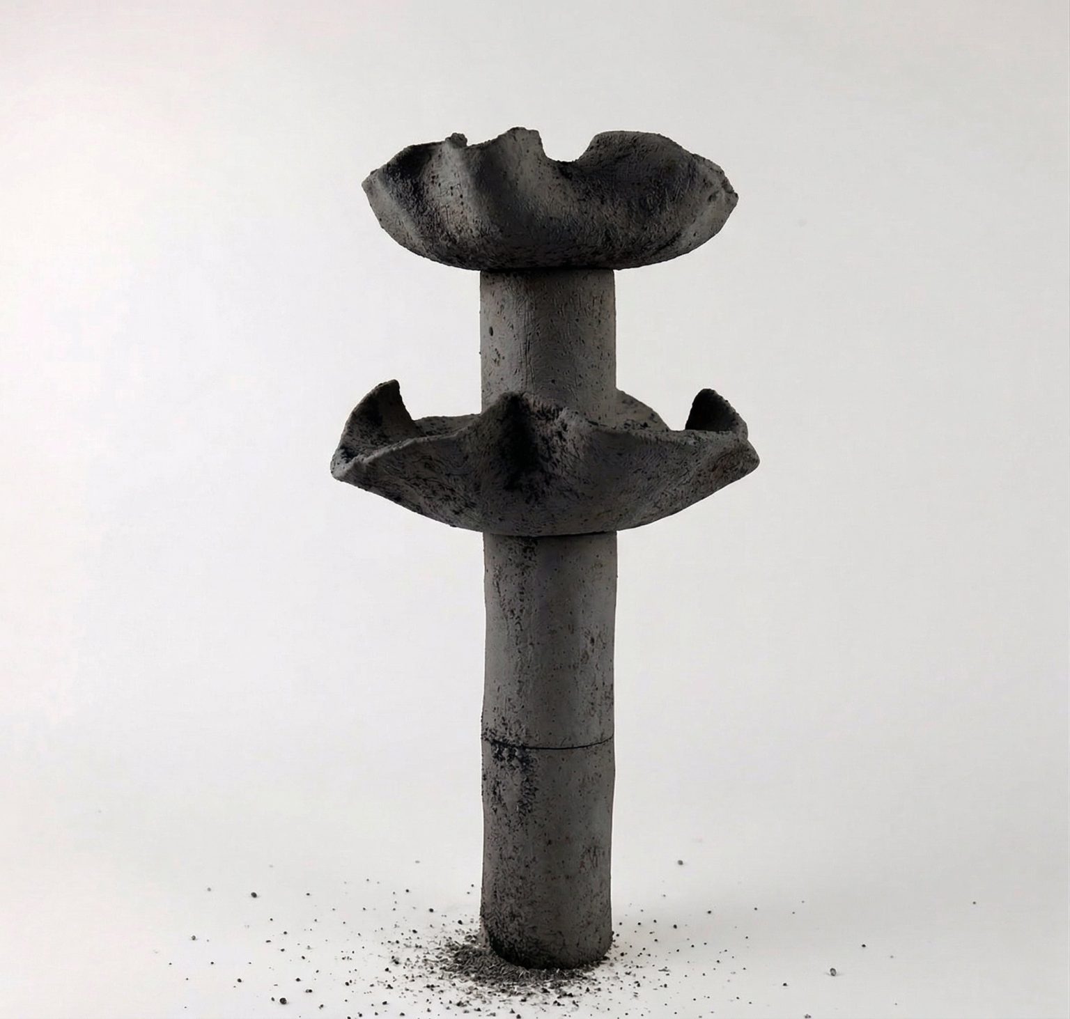 Delayed Matter by Elena Pelosi: dark ceramic column with two flared basins and a cracked surface