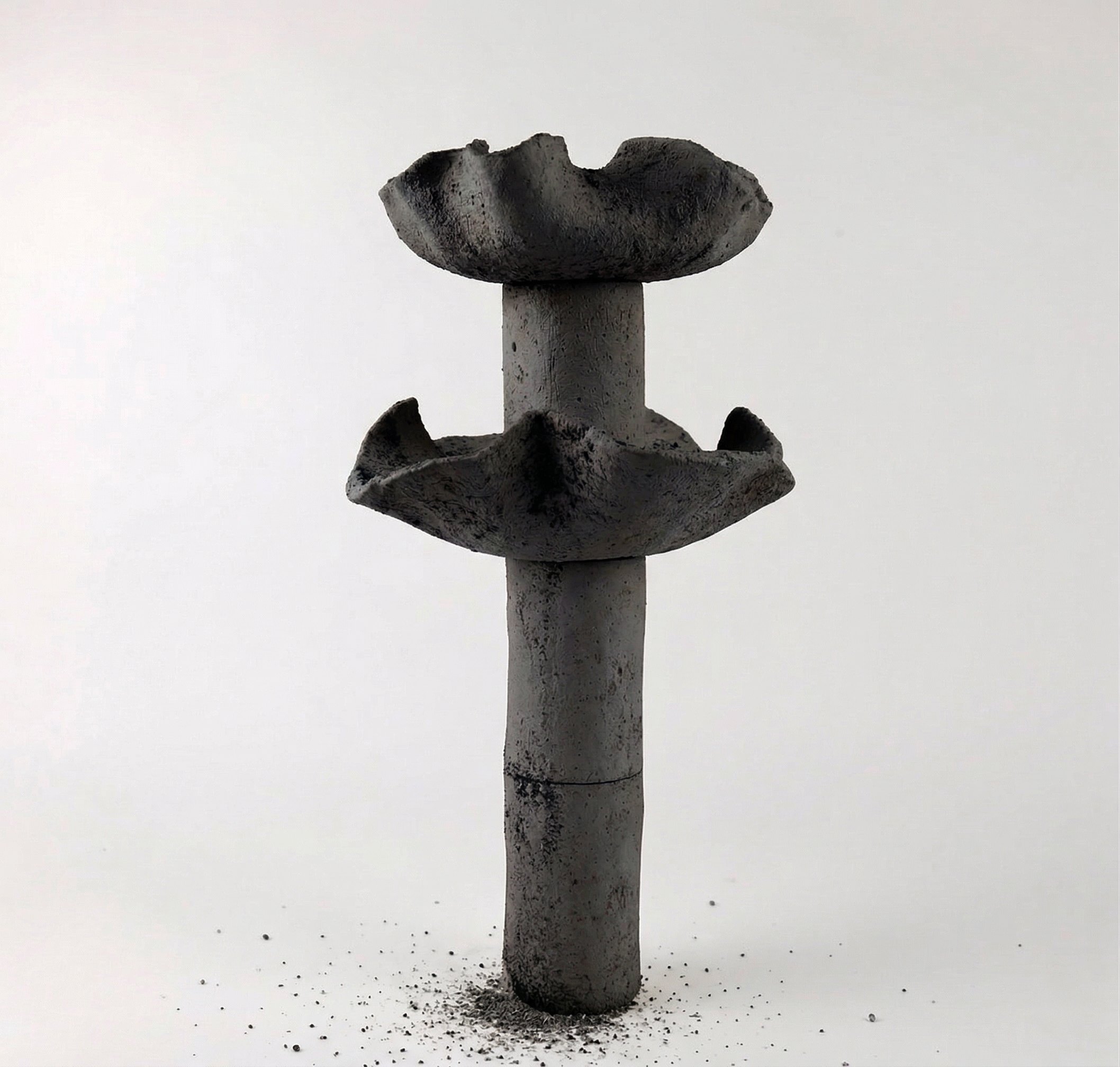 Delayed Matter by Elena Pelosi: dark ceramic column with two flared basins and a cracked surface
