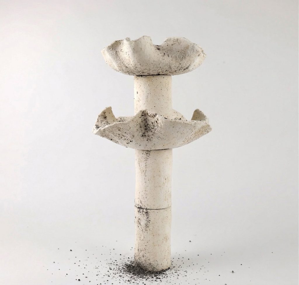 Delayed Matter by Elena Pelosi: pale ceramic column with two flared basins and mineral deposits